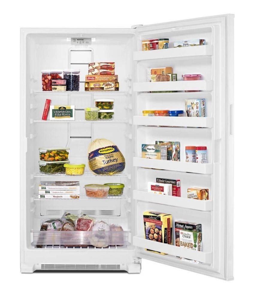 Open refrigerator with various food items on white background